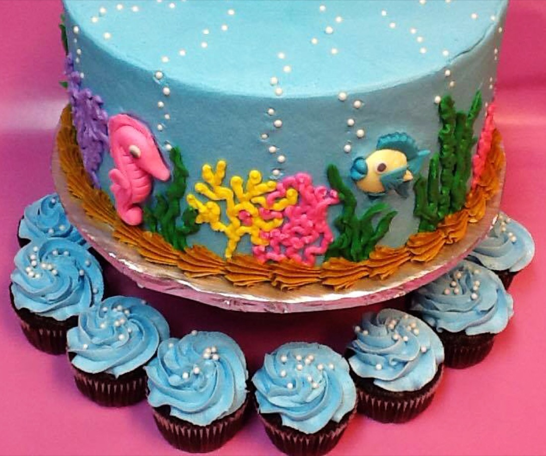 Under-the-sea themed cake with cupcakes