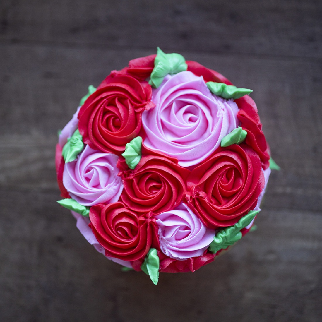 Dome cake covered in red and lavender roses