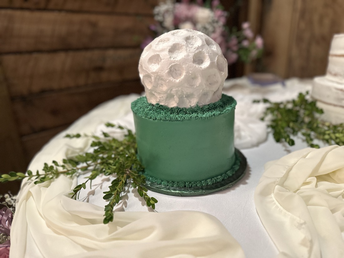 Golf-ball groom's cake with a green fondant base