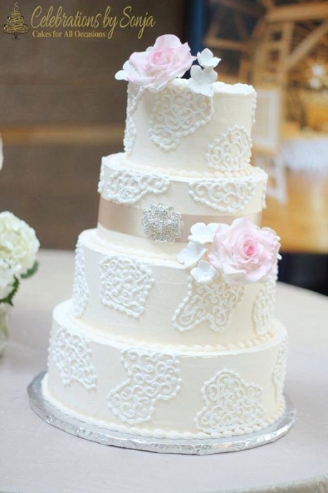 White lace wedding cake with blush roses