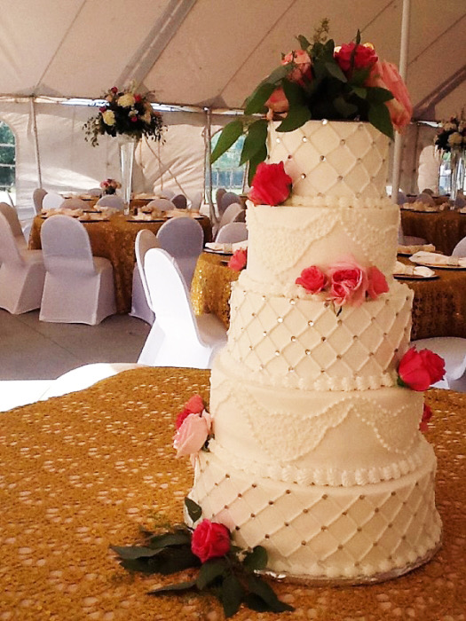 Naked textured wedding cake dressed with pink roses